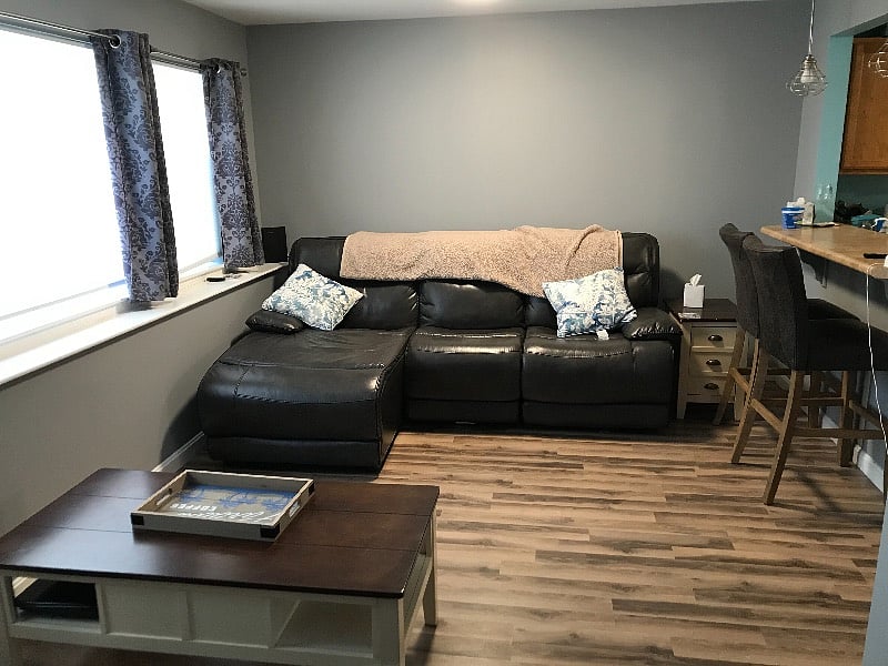 Power leather sofa and off to left two bar chairs