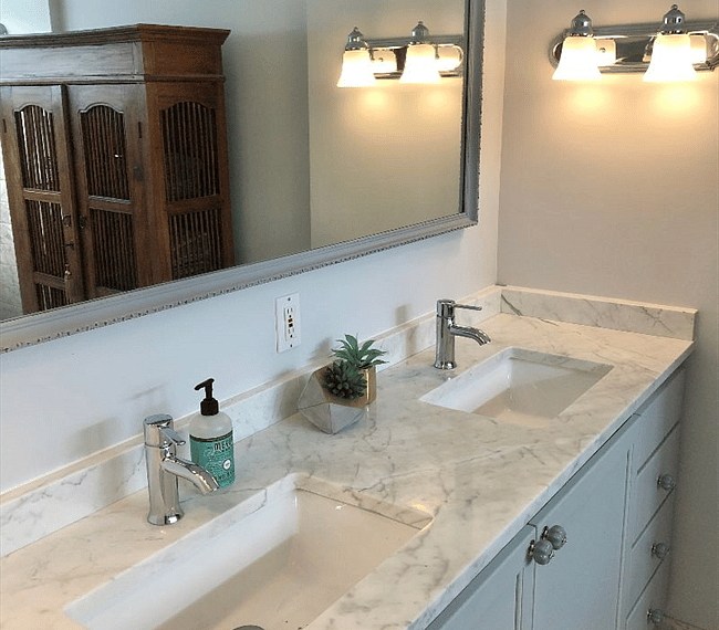 The bathroom is modern and stylish with shower, toilet and double vanity