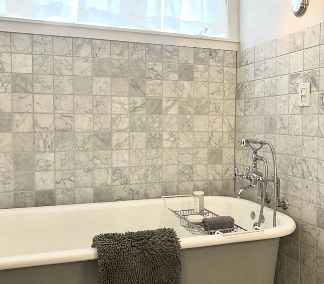 A shower and bath combo features in the bathroom