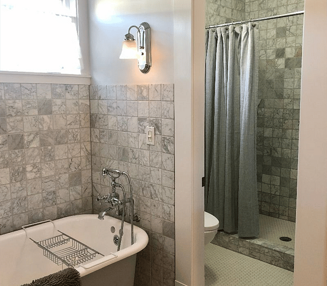 A shower and bath combo features in the bathroom