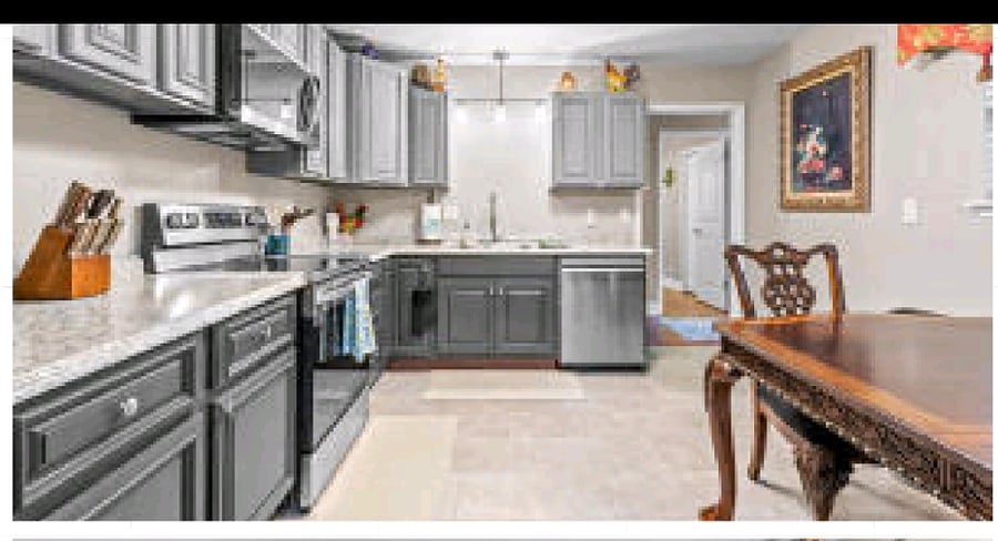 Kitchen has stainless appliances and plenty of seating. 