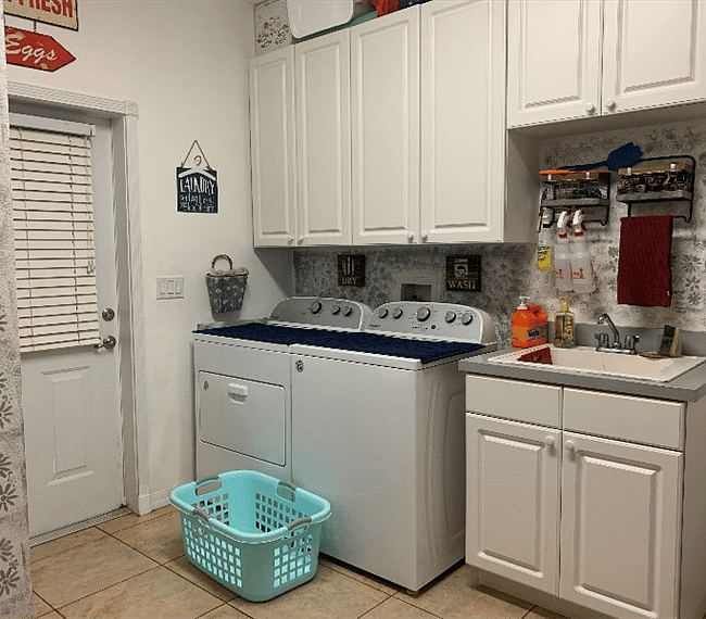 shared laundry room with drop down iron board and iron, sink for you to wash dishes