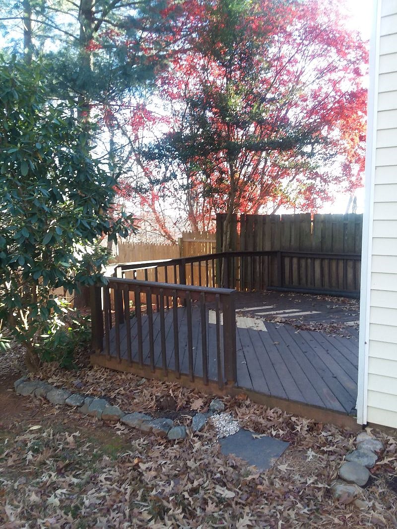 Closeup of private deck. Included are chairs and a gas grill