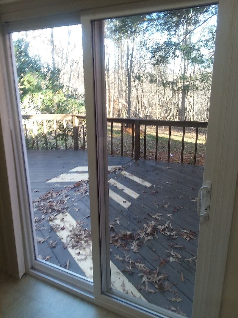 Sliding glass door looking onto private deck and backyard. No yard work other than gardening you may want to do.