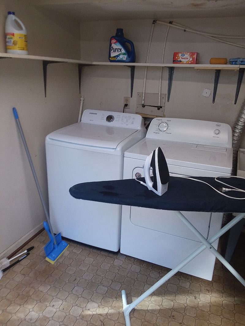 Nice laundry room with Samsung HE washer, large sized dryer, iron and board. Included are detergent and dryer sheets, clearing supplies. Shelves in room for storage,