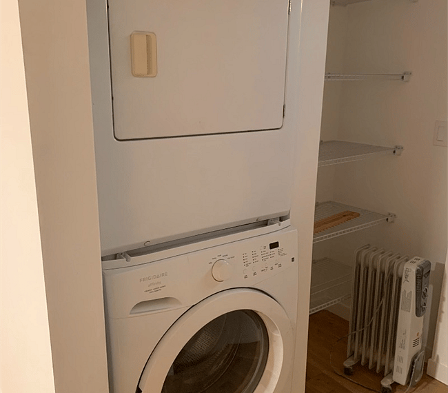 Laundry area with large walk in closet space.
