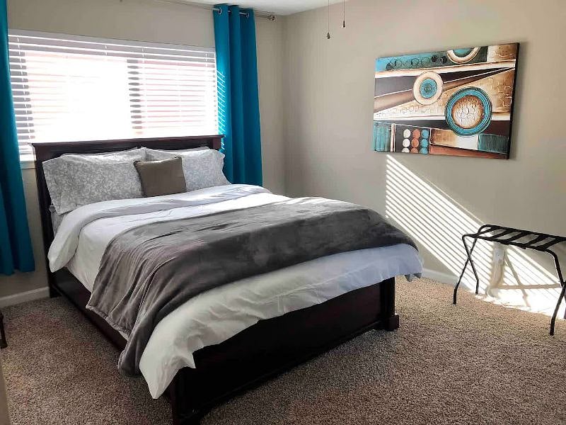 Master Bedroom - Queen bed, corner desk, TV, and 2 closets