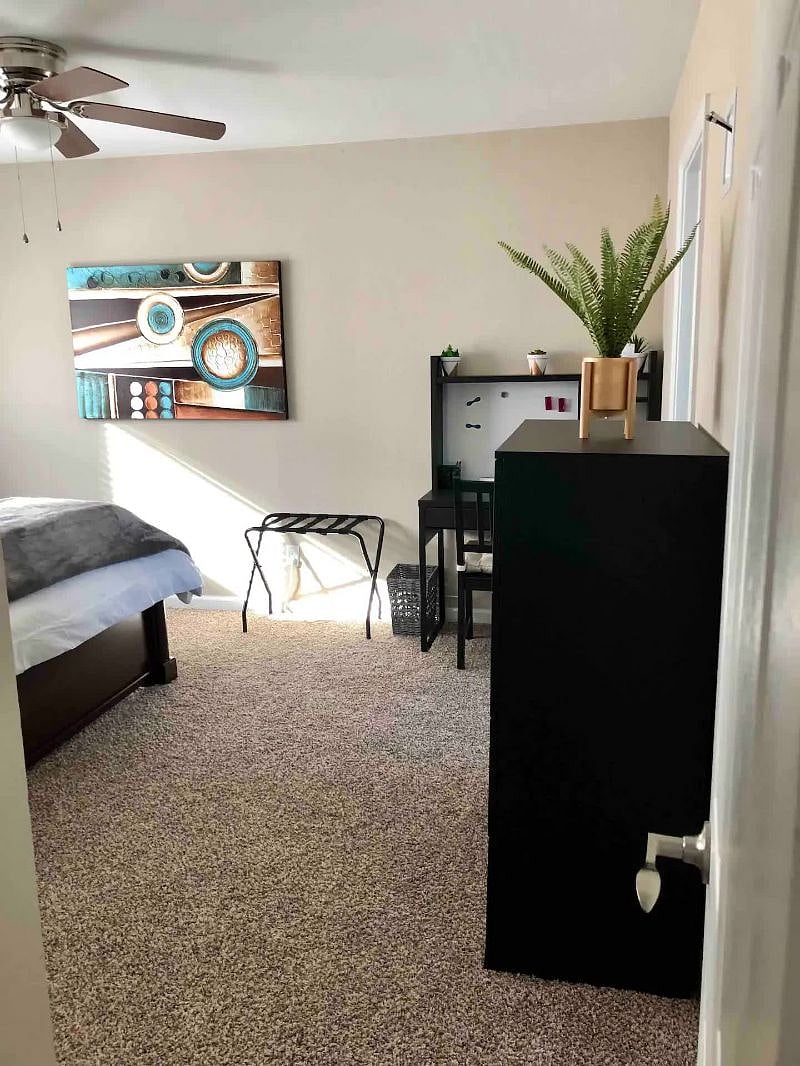 Master Bedroom - Queen bed, corner desk, TV, and 2 closets