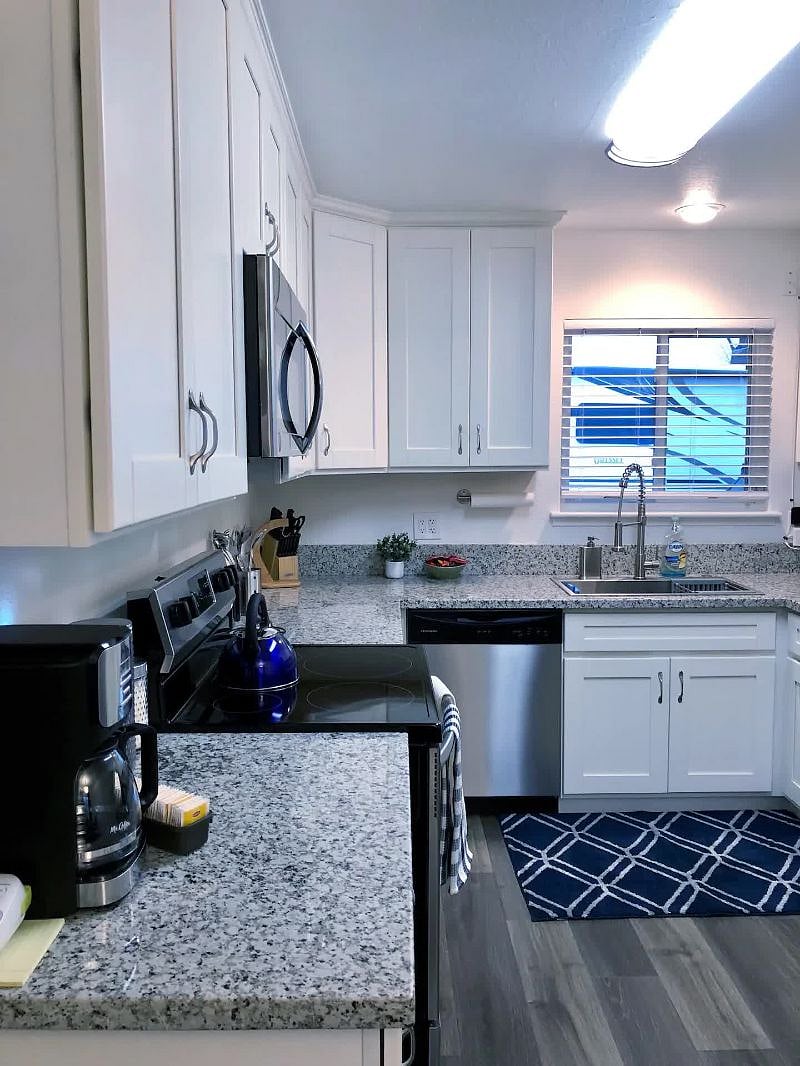 Kitchen with granite counters, new Frigidaire appliances, farm sink
