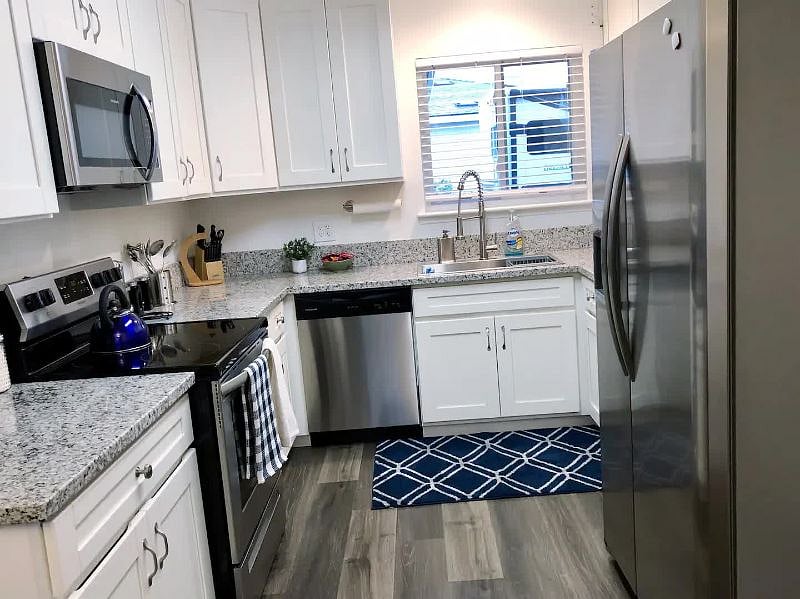 Kitchen with granite counters, new Frigidaire appliances, farm sink