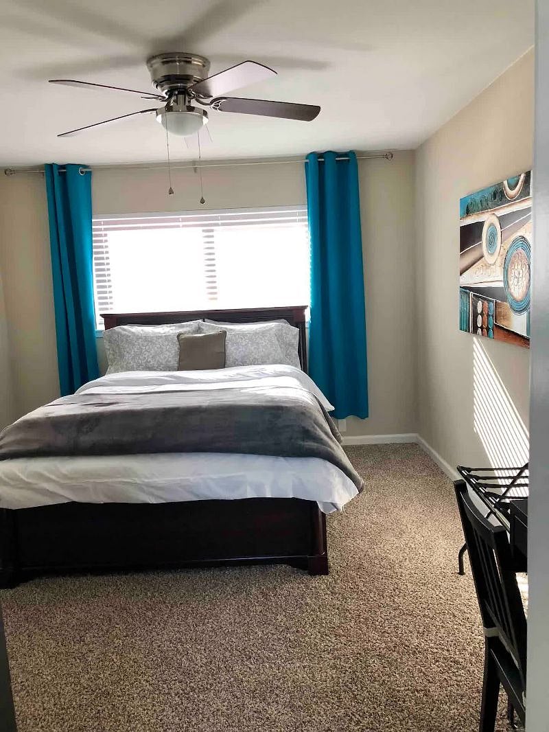 Master Bedroom - Queen bed, corner desk, TV, and 2 closets