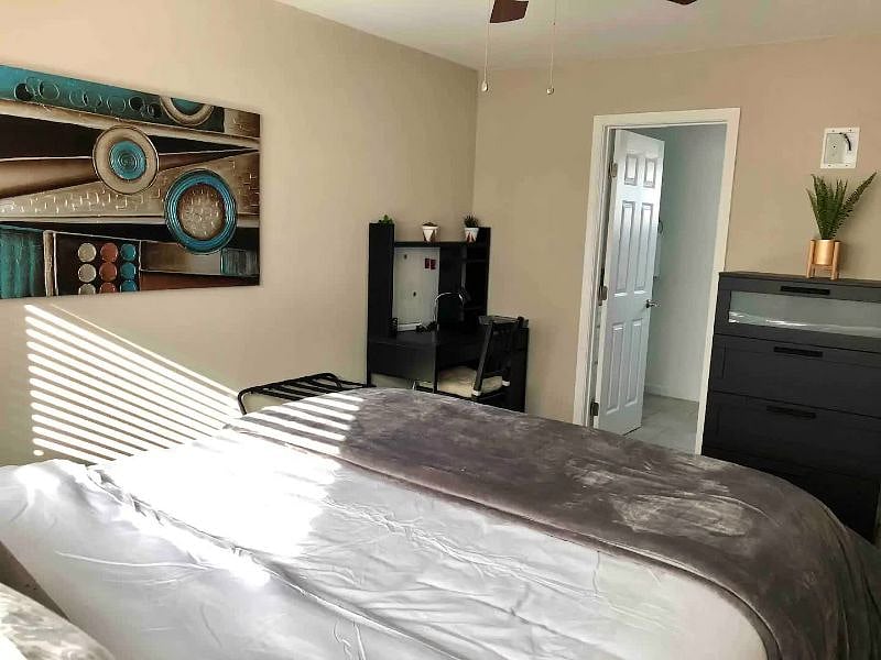 Master Bedroom - Queen bed, corner desk, TV, and 2 closets
