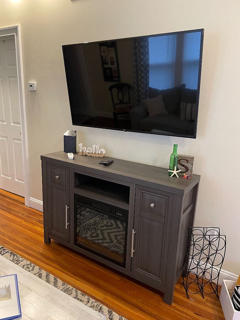 Large screen smart TV with faux fireplace. Both have remote control