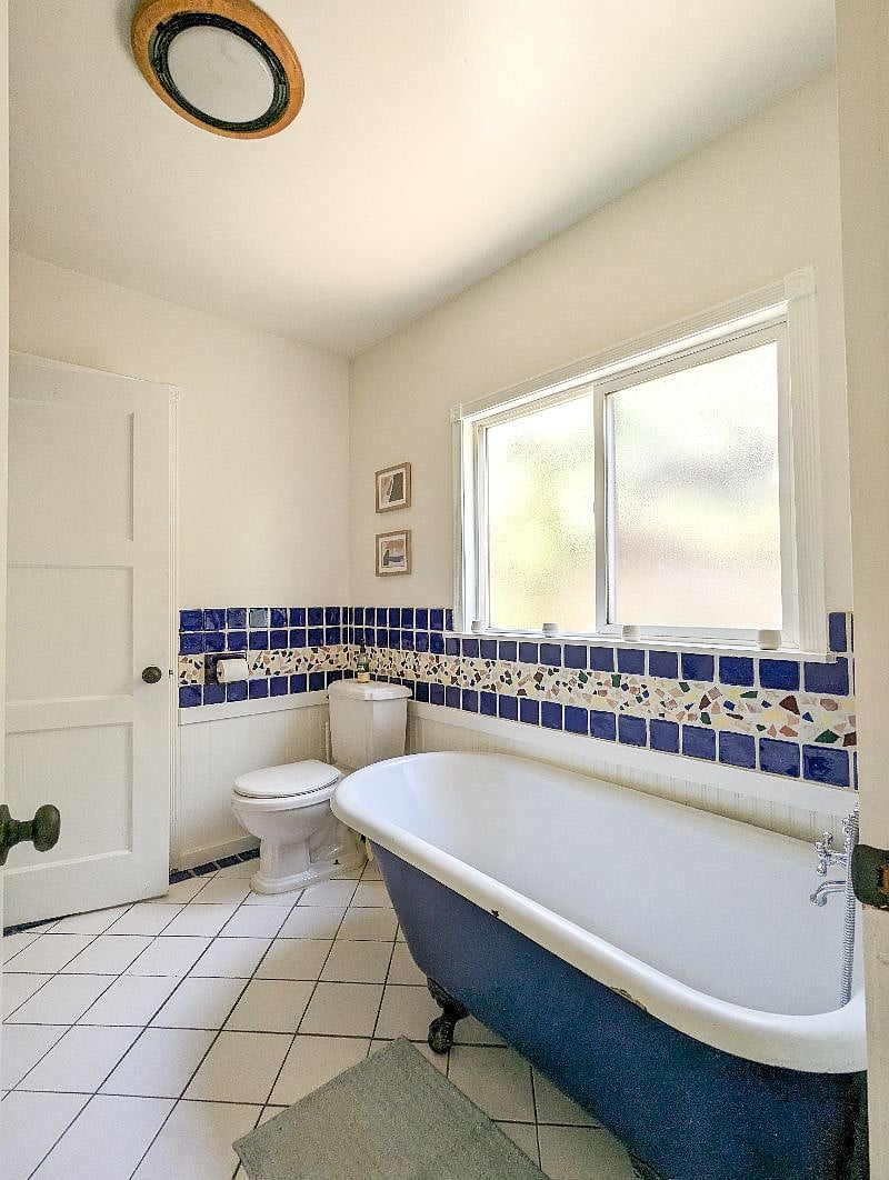 Bathroom has full sized claw tub and detached shower.