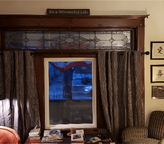 stained etched glass window overlooking from porch from living room