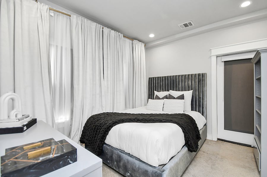 1st floor bedroom with queen bed, dresser, and en suite full size bathroom.