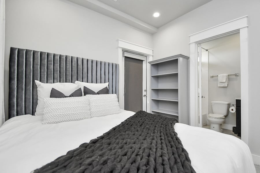 1st floor bedroom with queen bed, dresser, and en suite full size bathroom.
