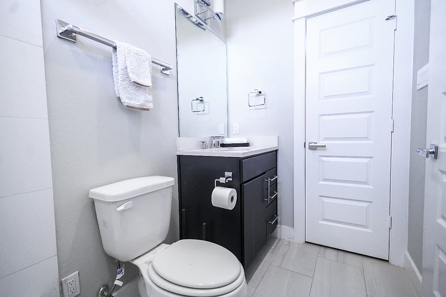 1st floor en suite bathroom with walk in closet, upgraded tub / shower combo, single vanity and toilet.