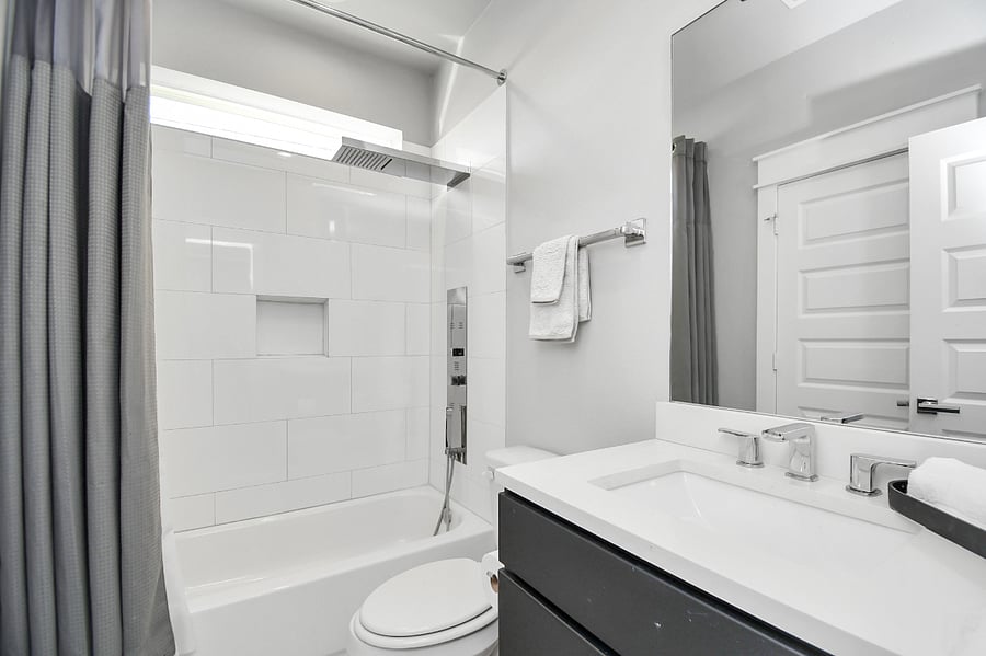 1st floor en suite bathroom with walk in closet, upgraded tub / shower combo, single vanity and toilet.