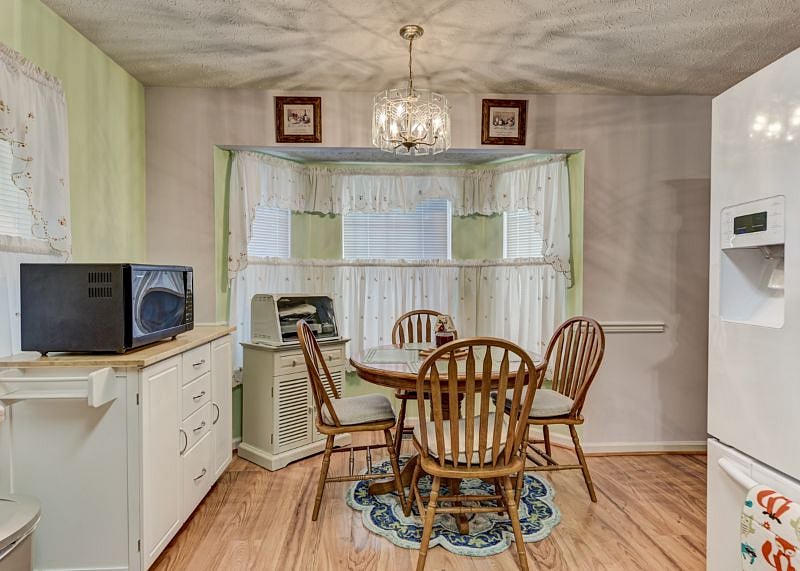 Kitchen table and chairs in front of a bay window