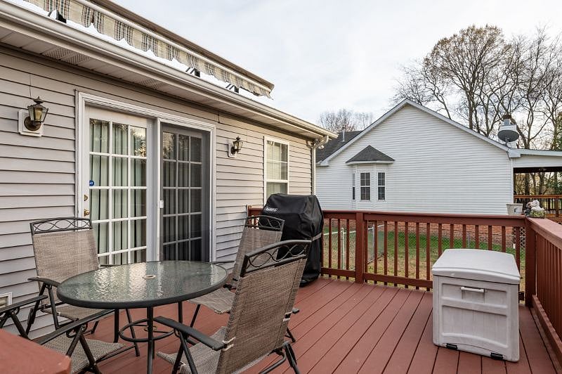 Back deck with patio furniture and gas grill