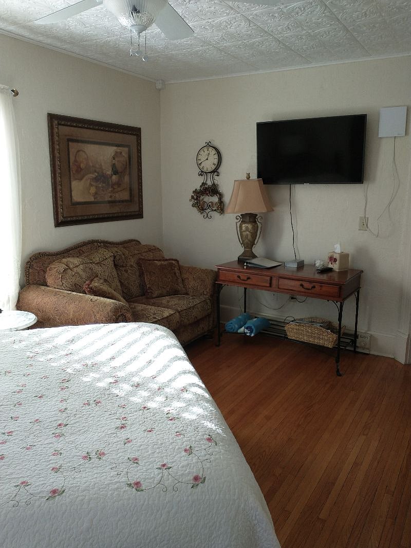 Love seat, desk, and smart TV.