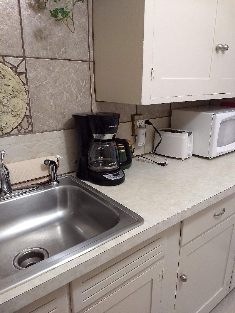 Microwave, toaster, coffee pot, crockpot, blender, and popcorn popper.