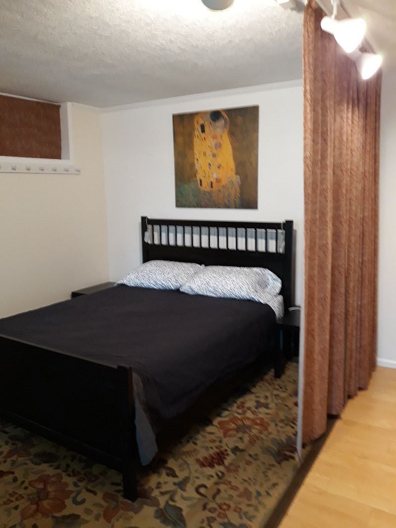 Open modern plan. Curtains to open/enclose bedroom area for privacy.