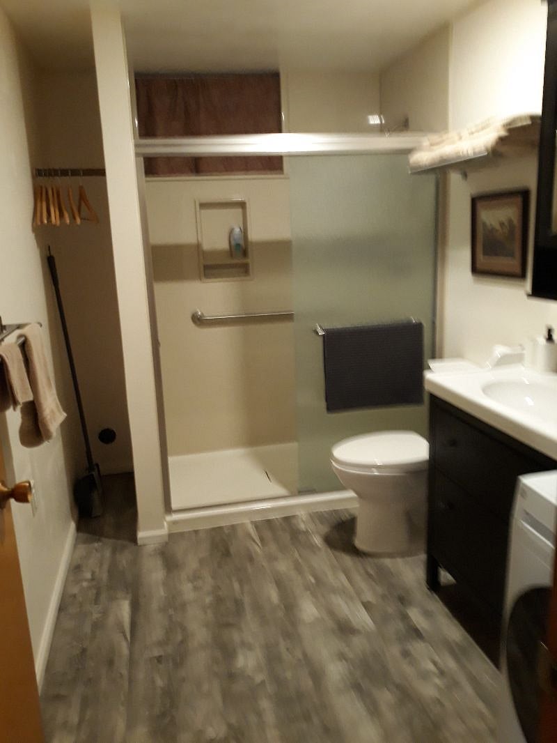 Modern bathroom with all-in-one washer and dryer.