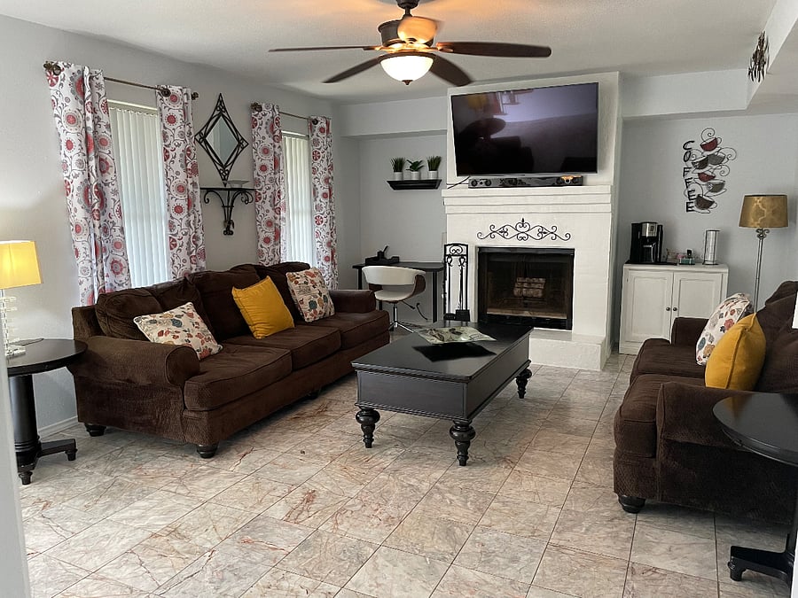 Living Room with plenty of sitting, desk to do work, coffee station and smart 55in TV.