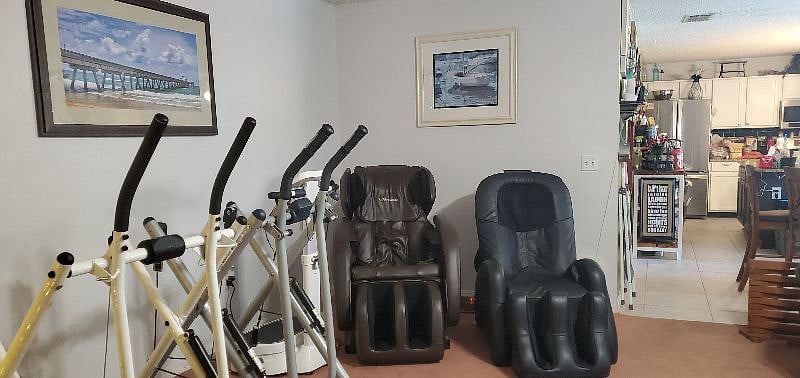 Two massage chairs and exercise equipment (gliders).