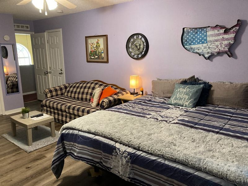 This is one of our four bedrooms, "New King Room" each with their own private restroom and showers. This particular room is Room E and features a king size, adjustable bed and pull out couch.