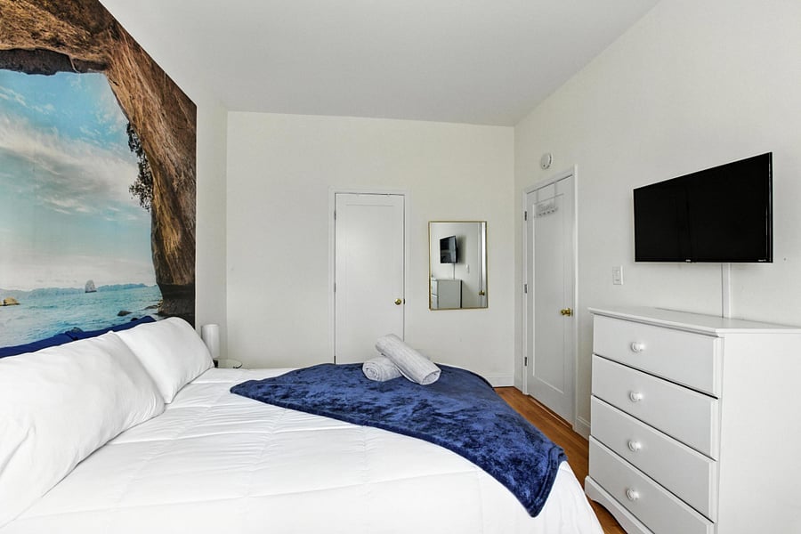 Guest private bedroom with full size bed, dedicated work station and chair, smart mount tv, closet space and windows for fresh air and sunlight. A nice room to spend time in.
