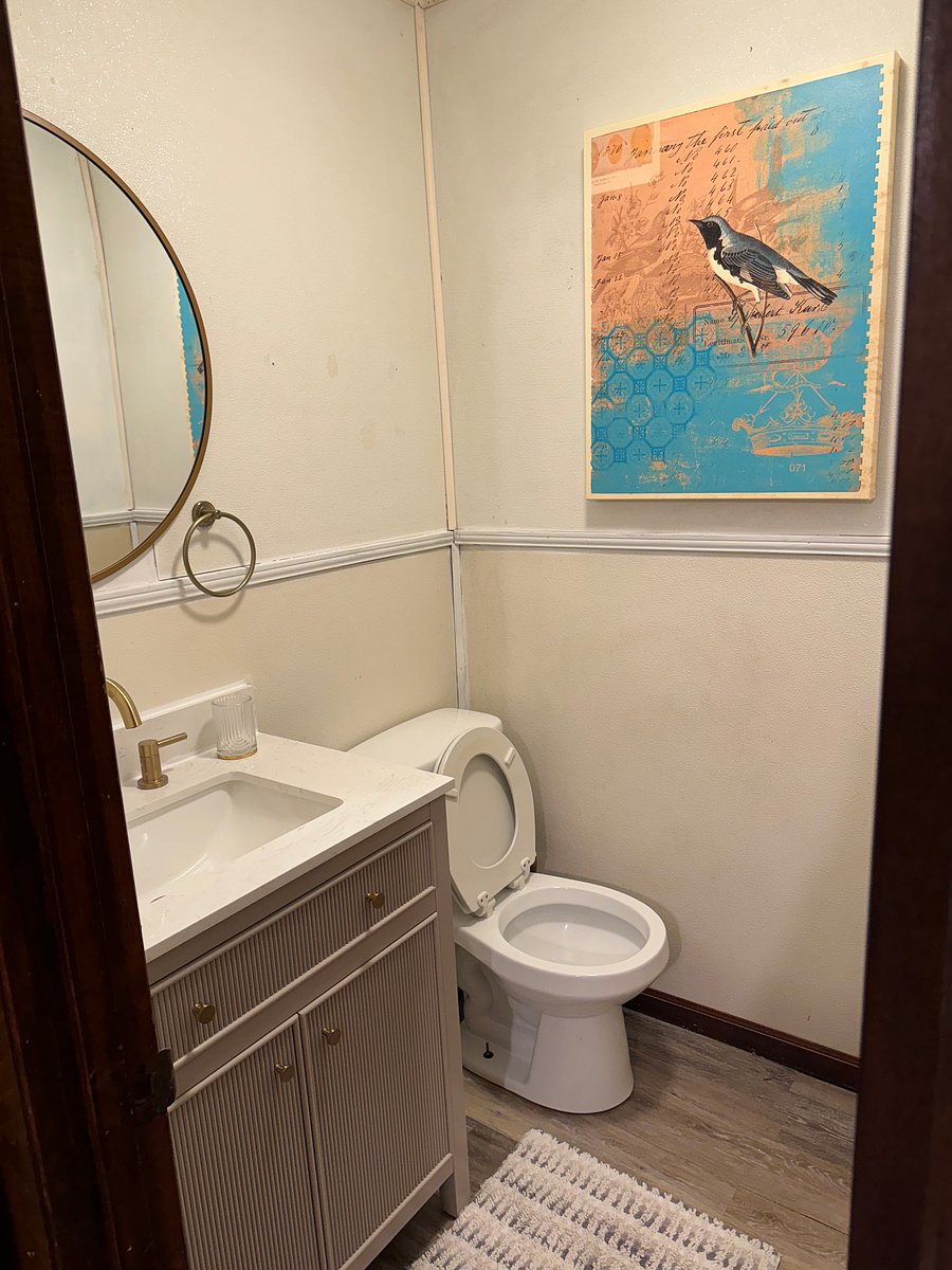 Separate room with toilet and sink .