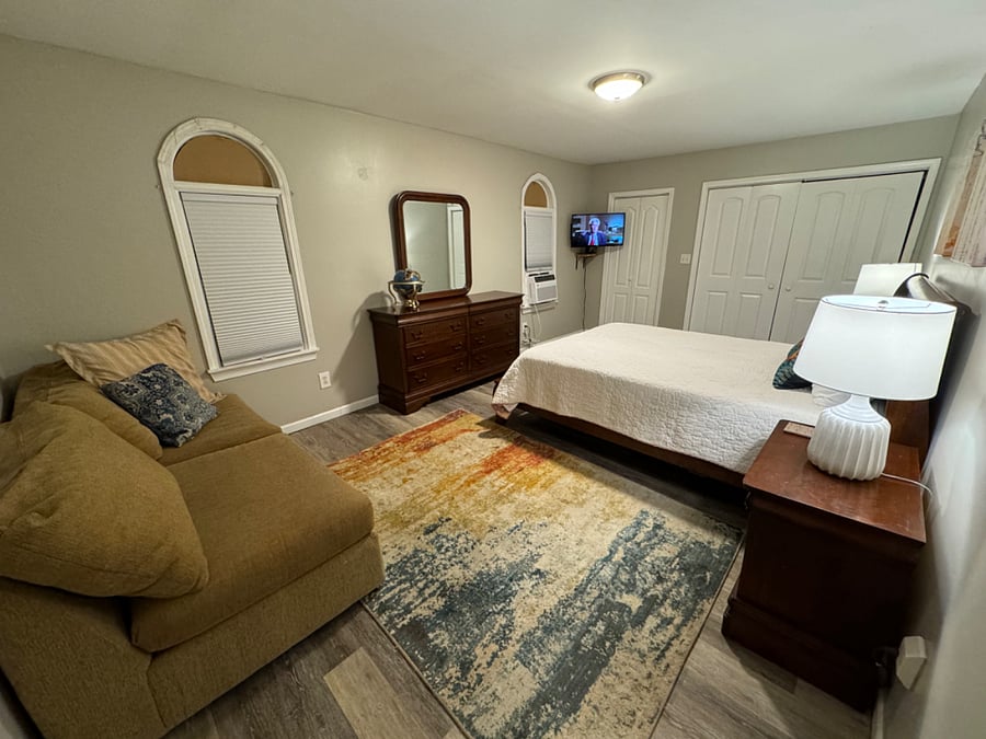 Sofa for lounging; queen bed; closet with shelves ,racks and hidden laundry room.