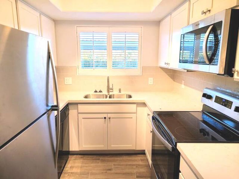 Complete full kitchen with refrigerator, dishwasher, stove, microwave and coffeemaker.