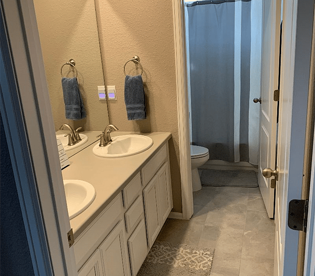 The bathroom is modern and stylish with shower, toilet and vanity.
