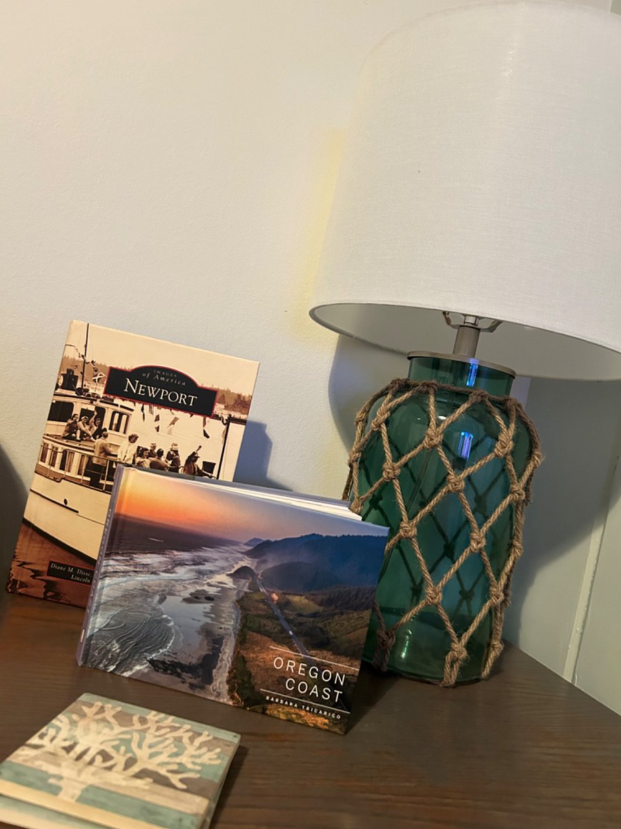 Nautical themed lighting in living room with books highlighting local history and Oregon coastline 
