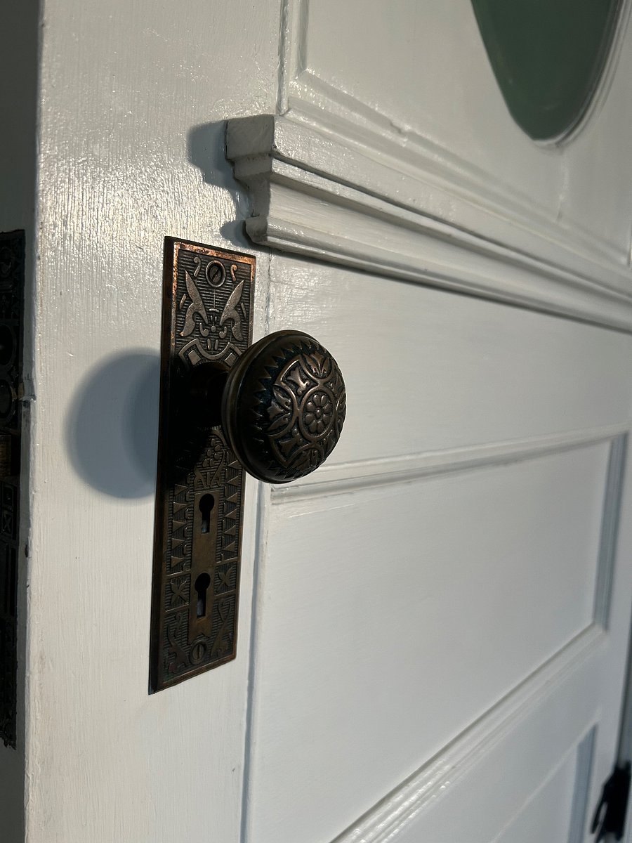 Original antique hardware from the 1920s on door leading to master bedroom