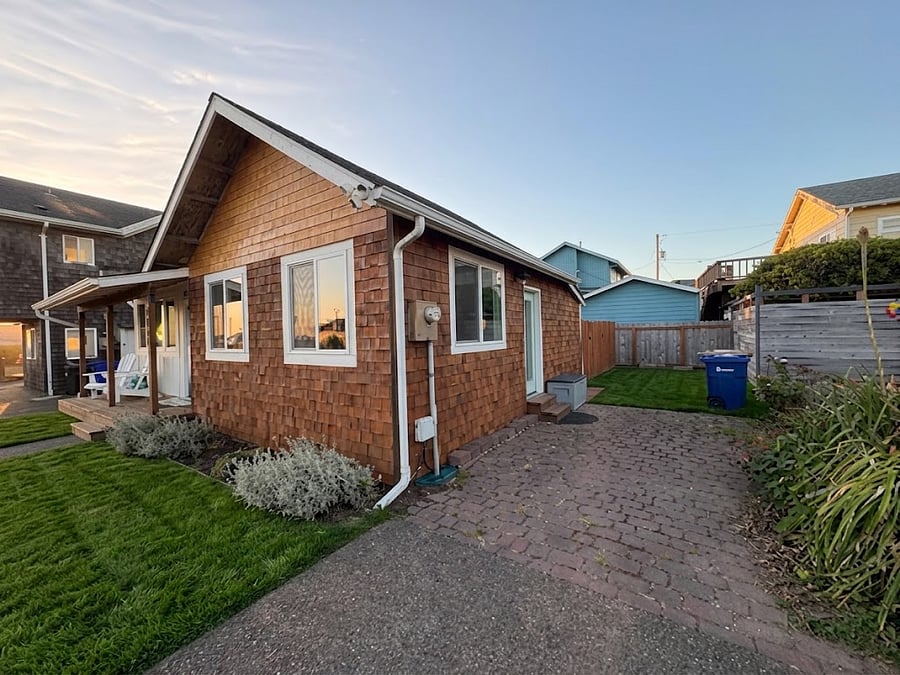 Dedicated off-street parking for up to two vehicles is conveniently located alongside the home, offering easy access and plenty of space for luggage, groceries, and travel essentials.
