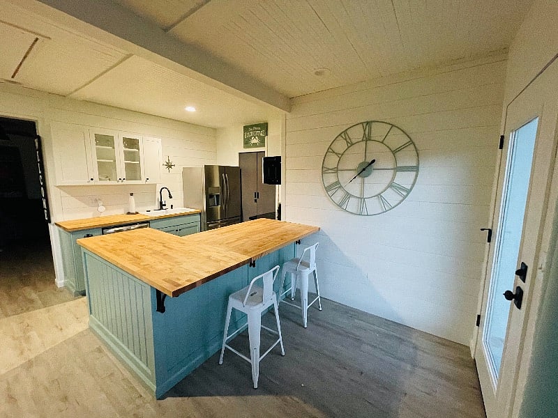 Custom butcher block counters with additional bar seating.
