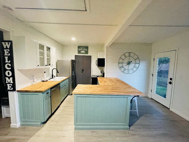 The kitchen includes full size stainless steel refrigerator, dishwasher, oven and microwave.