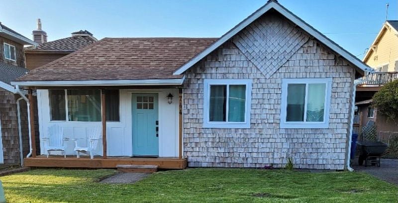 Cedar shake exterior adds to the charm of the home. The Adirondack chairs allow you the ability to relax and enjoy the sights and sounds of the ocean from the front porch.