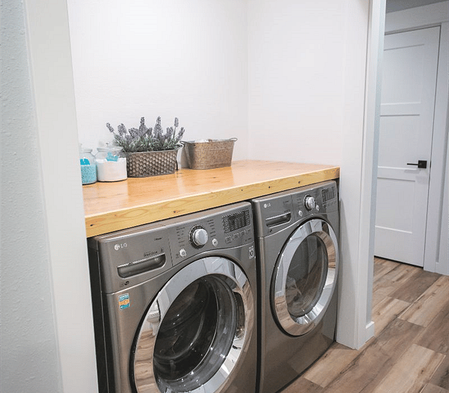 laundry area with new LG HE washer and dryer