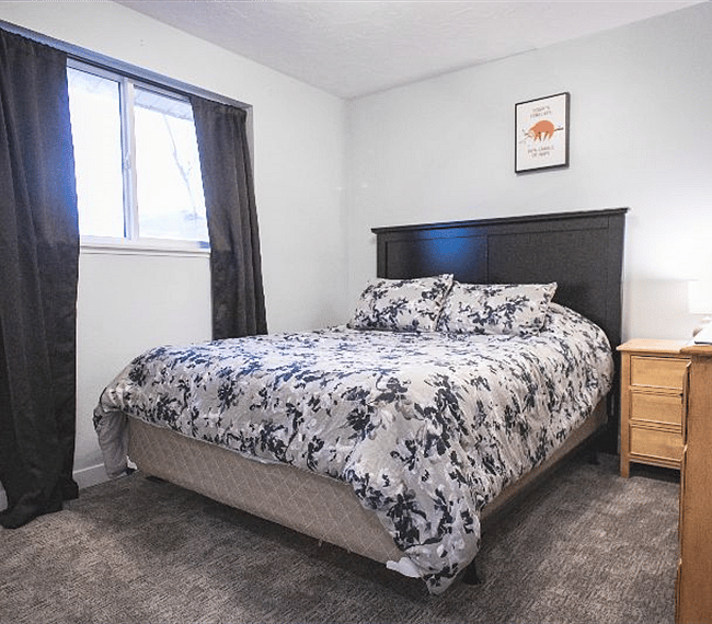 guest bedroom #1. this bed currently in home, queen size. blackout curtains included