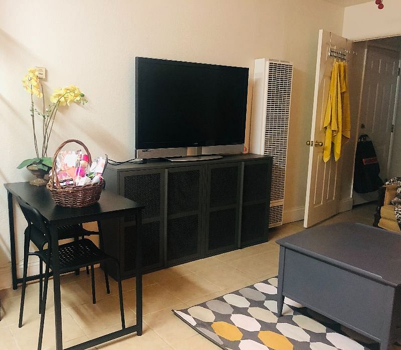Big Screen TV with wifi internet. Cabinets under the TV are all storage space. Orchid arrangement. A welcome spa basket is provided.