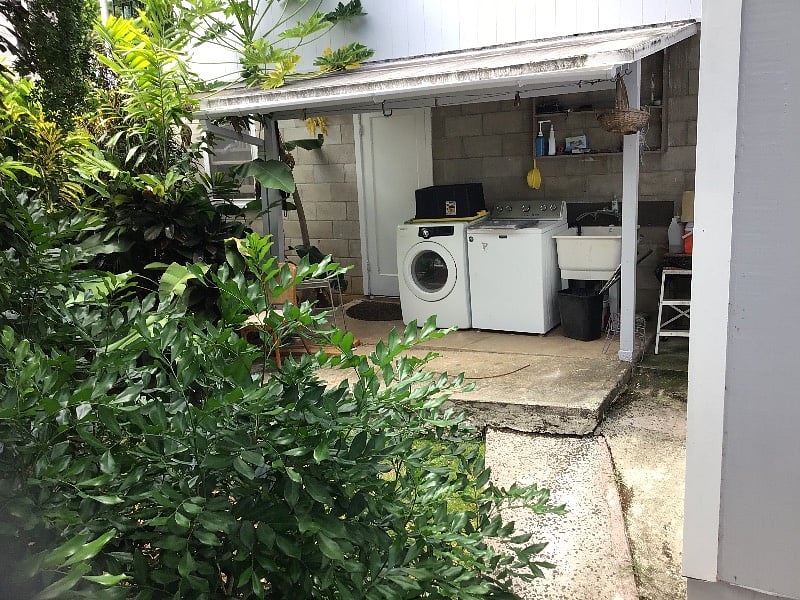 Washer/dryer, clothesline and utility sink, behind the carport and is totally PRIVATE for you only. That door to the  left side of the dryer, comes from the carport, which faces grandpa Banyan and the street. There is some limited yard space in front of the w/d use for exercising or stretching- 