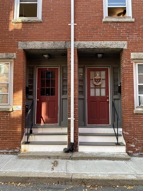 Front doors to building. This unit enters on the left and walks up on flight of stairs