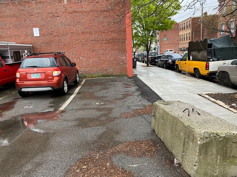 The open parking lot. Parking for one car. If additional parking is needed, You can purchase a pass with the city to park on street in residential parking. 