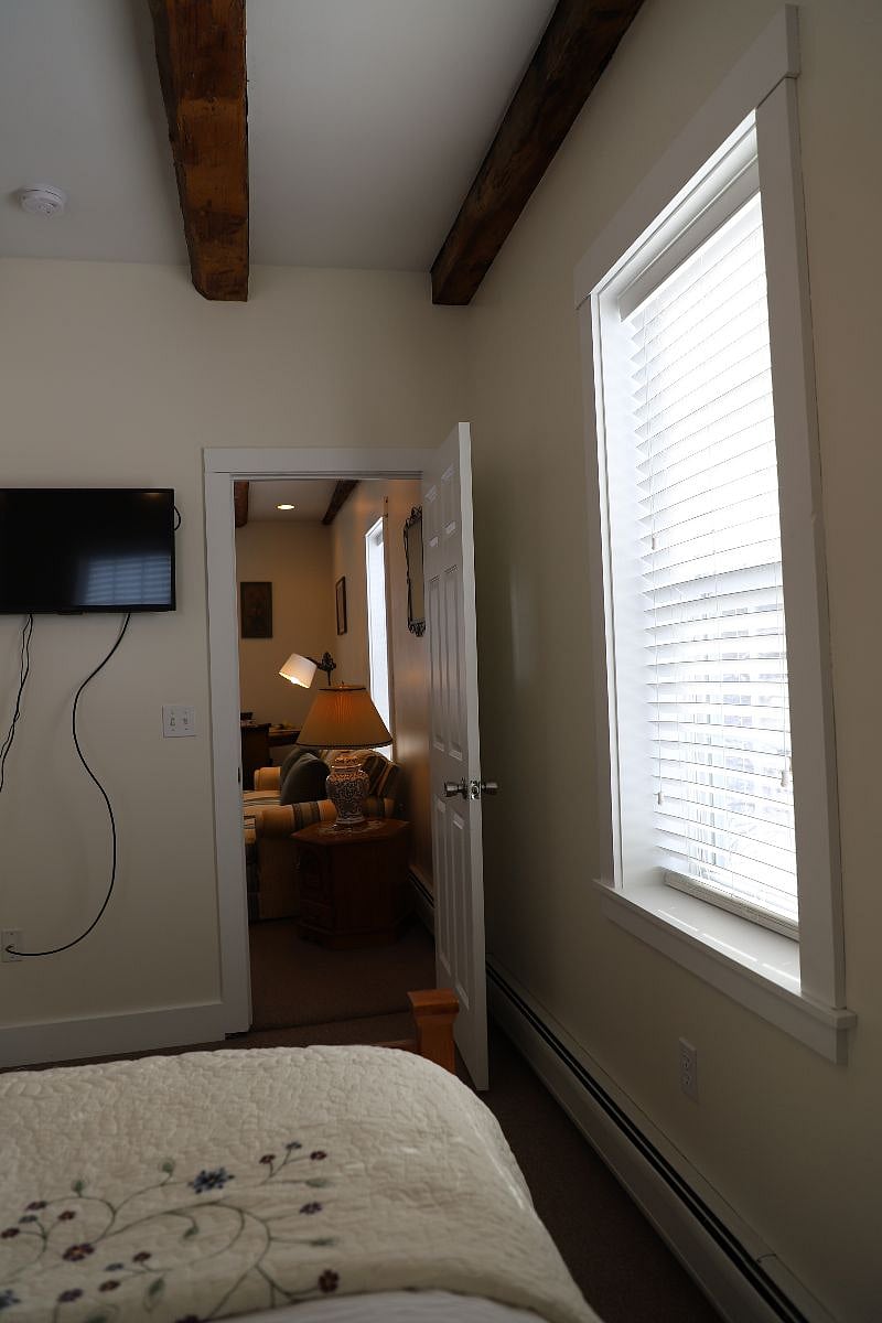 Unit C TV in the bedroom and entrance to the living area
